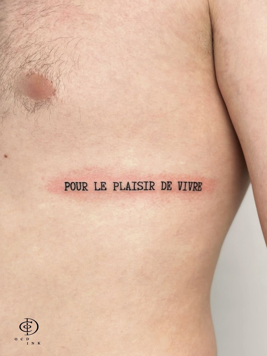 Tattoo Areas for Guys: Top Spots and Style Tips A script in typewriter font tattoo on the rib by OCD Ink Studio in Hanoi