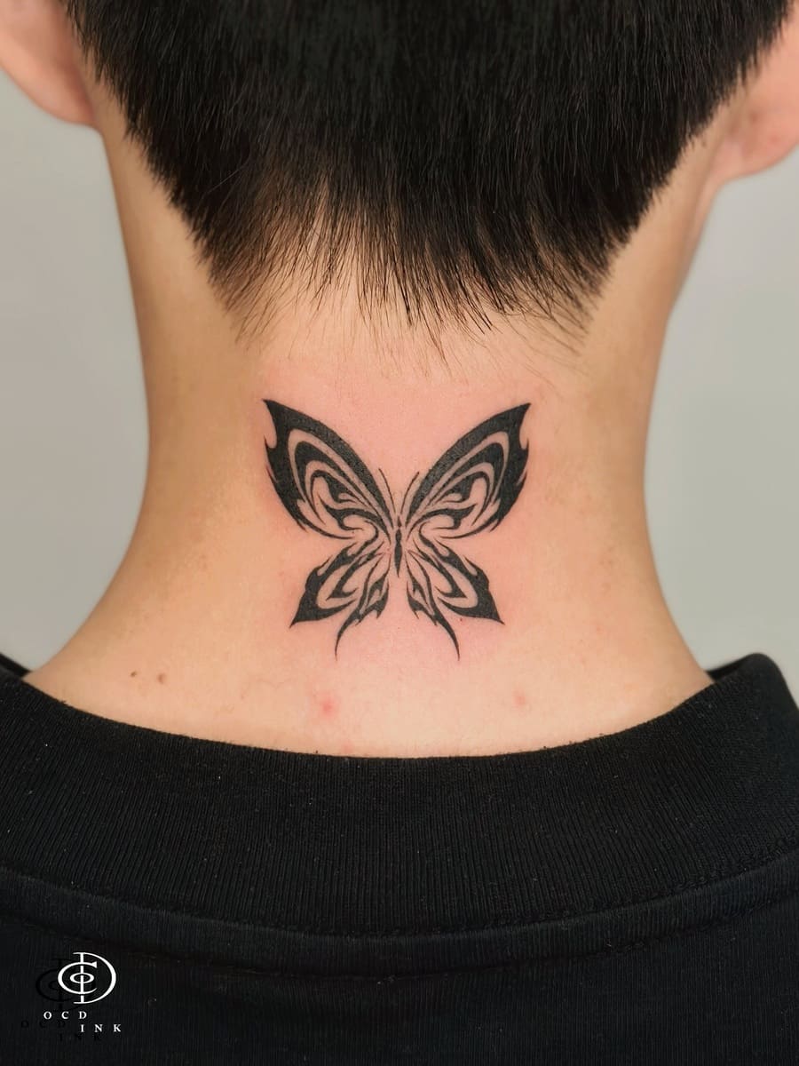 Tattoo Areas for Guys: Top Spots and Style Tips Black butterfly tattoo on the neck by OCD Ink Studio in Hoi An