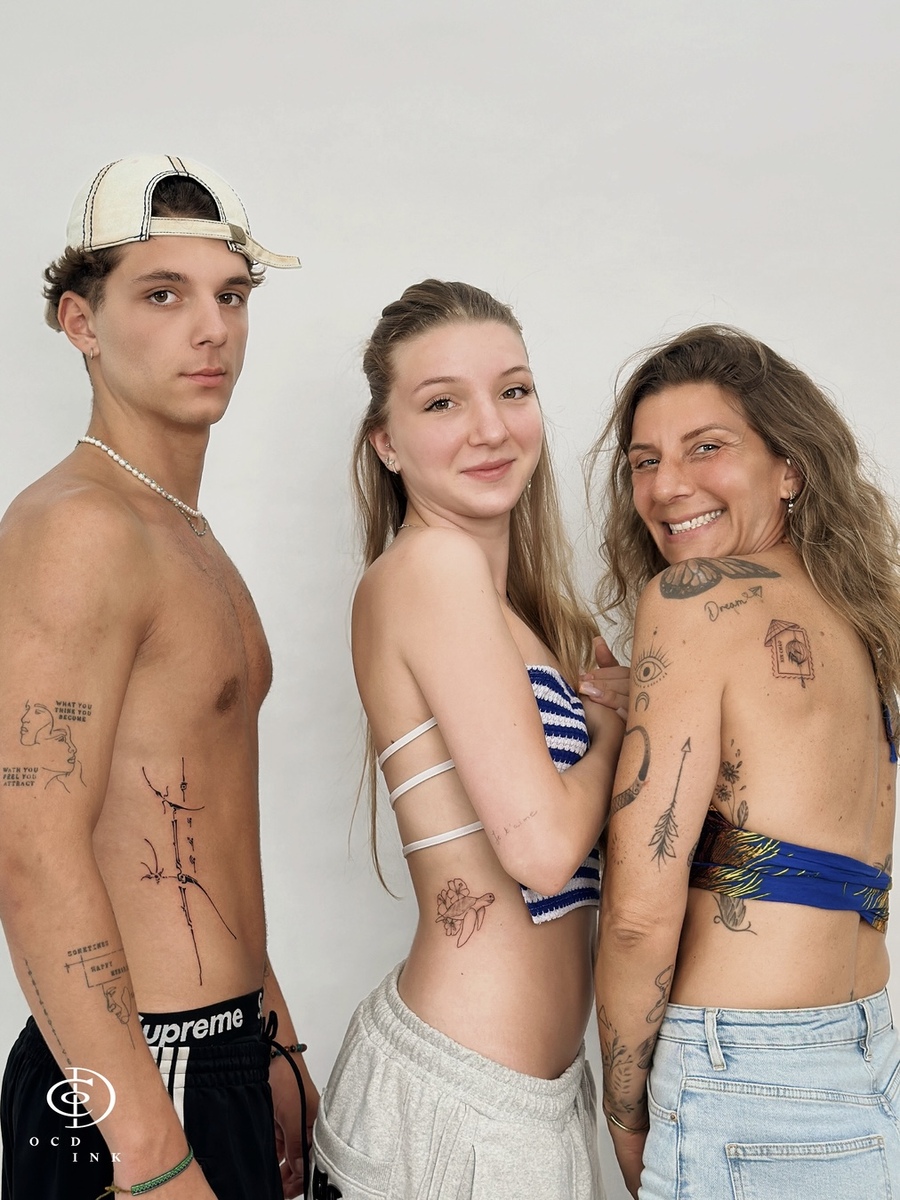 Laurence and her children showcasing their delicate fine-line tattoos at OCD Ink Studio Hanoi.