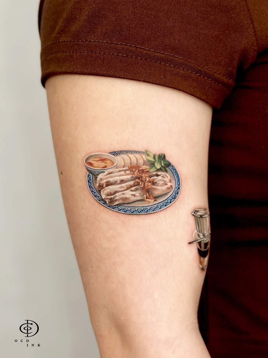 A tattoo of a color realistic rice noodle roll on the arm by OCD Ink Studio Hanoi