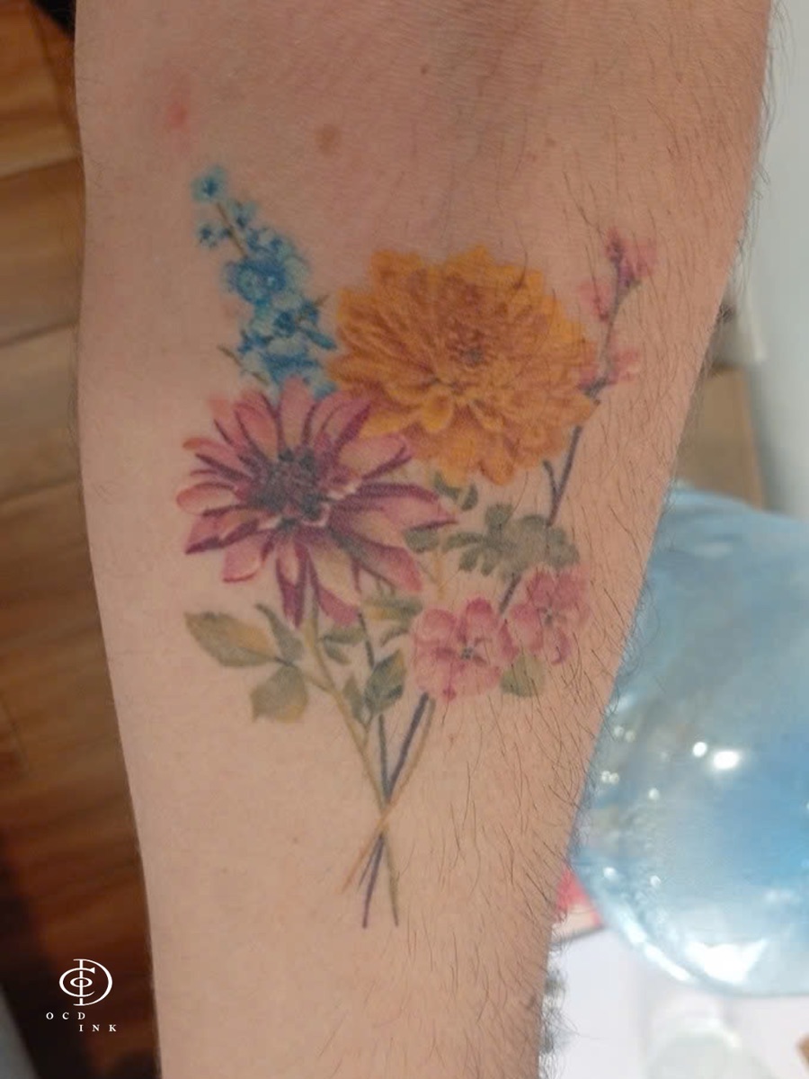 A healed color realistic flower bouquet tattoo on the forearm by OCD Ink Studio Vietnam