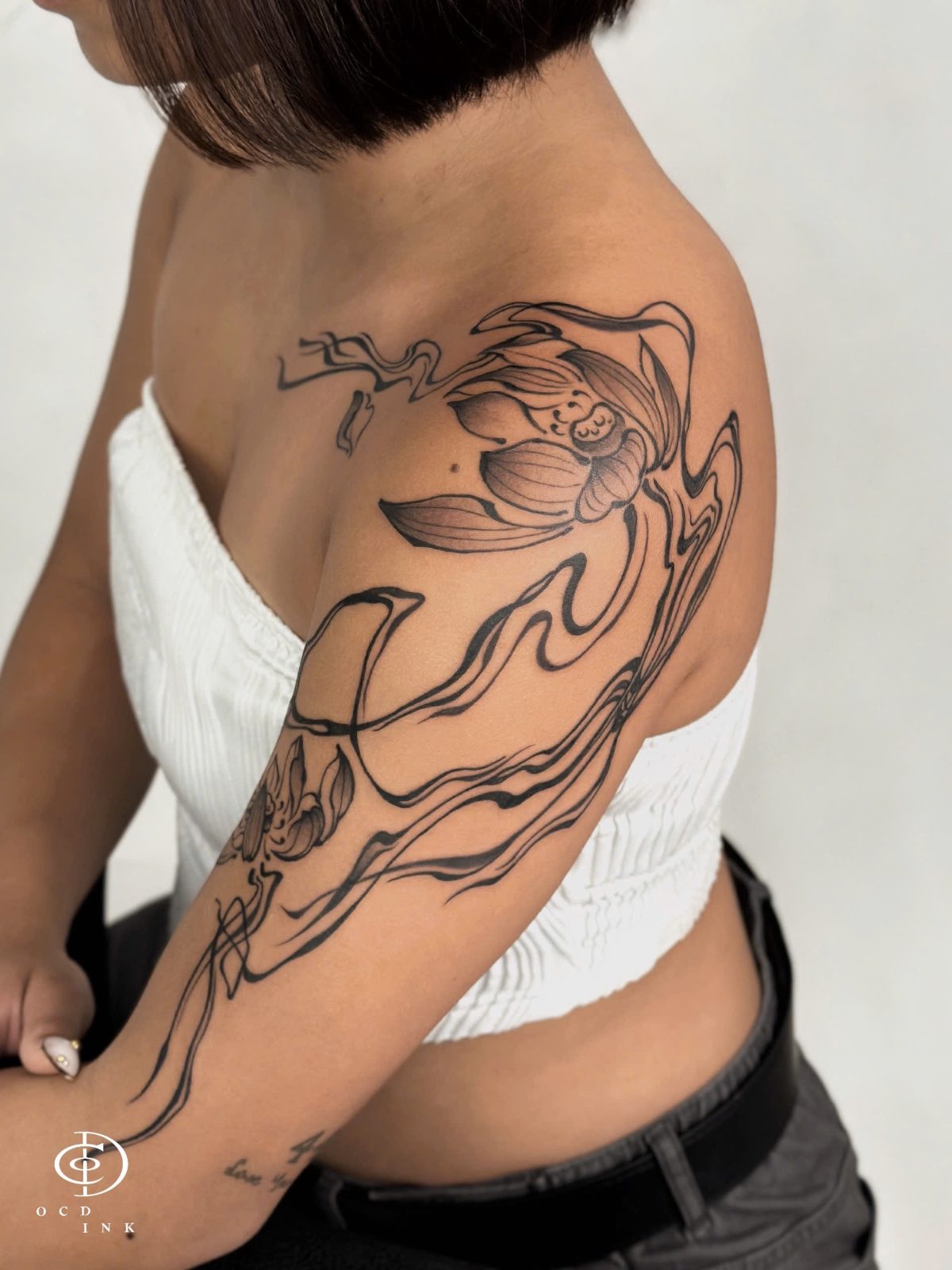 Blackwork lotus and flow tattoo - OCD Ink Studio