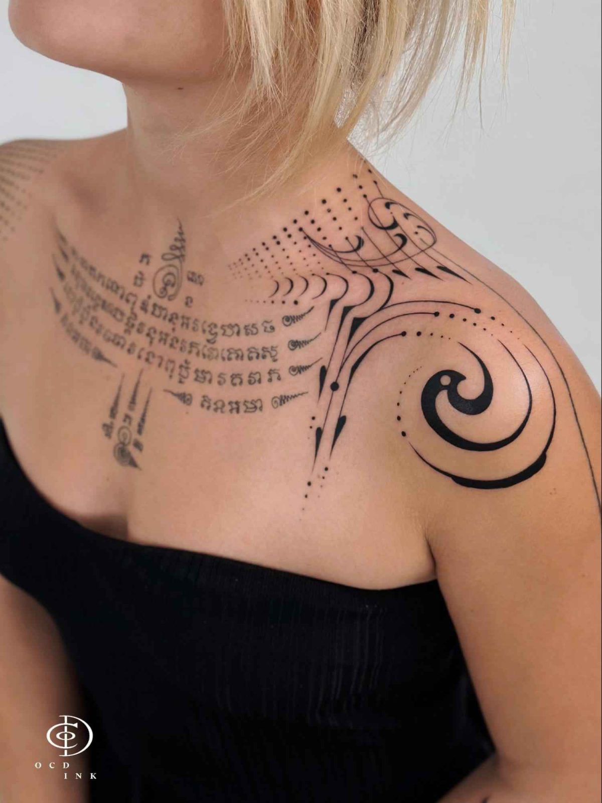 Blackwork Blackwork geometric tattoo with abstract spirals, dotwork patterns, and flowing linework across the shoulder