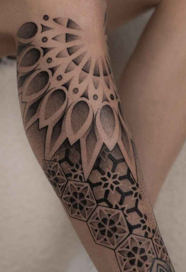 Geometric ornamental tattoo featuring layered mandala elements, sacred geometry patterns, and dotwork shading