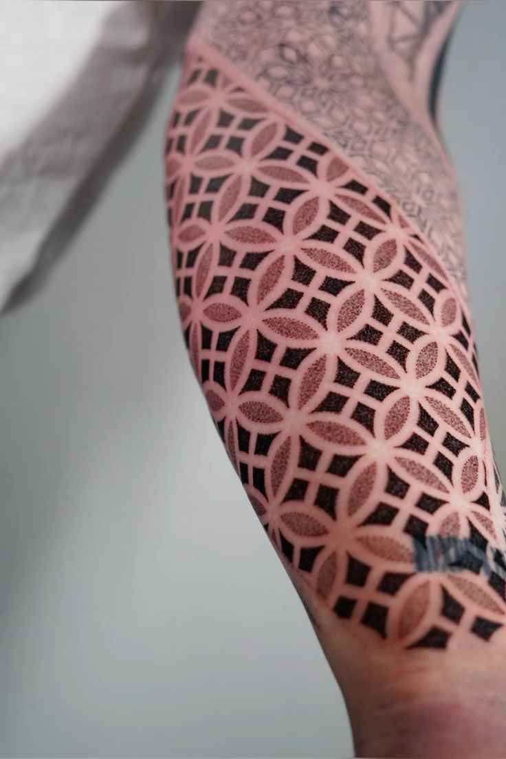 Geometric ornamental tattoo featuring a flower of life pattern with dotwork shading and repeating sacred geometry