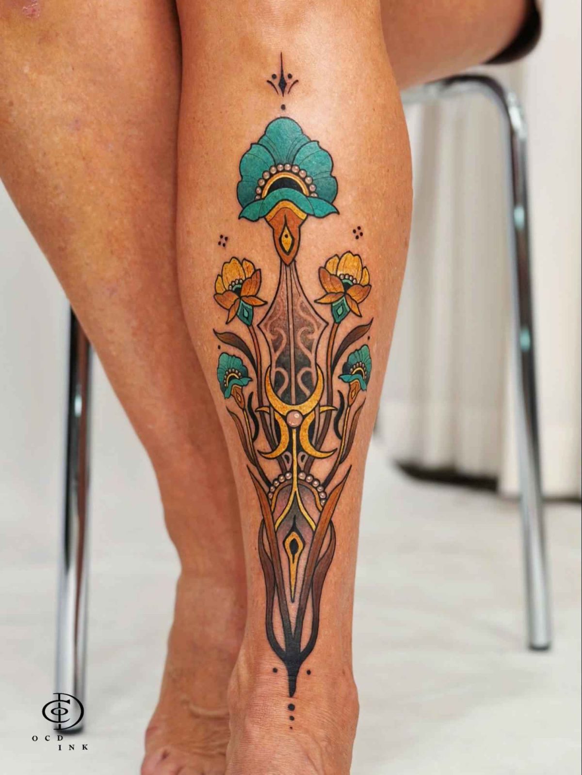 Flower ornamental tattoo featuring stylized blossoms, Art Nouveau-inspired curves, and symmetrical decorative elements