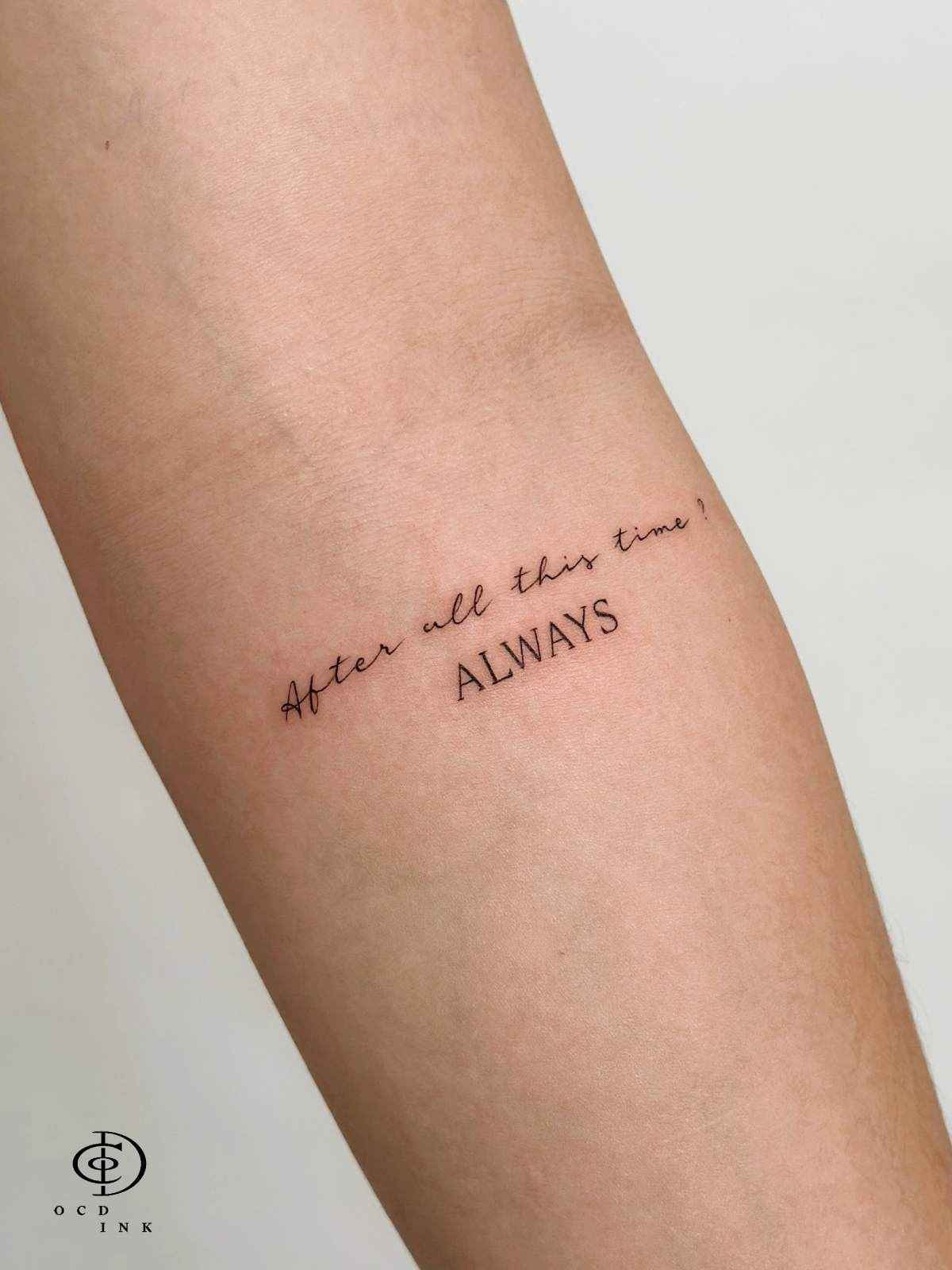 Fine line lettering tattoo featuring a meaningful quote with minimalist script and serif typography on the forearm