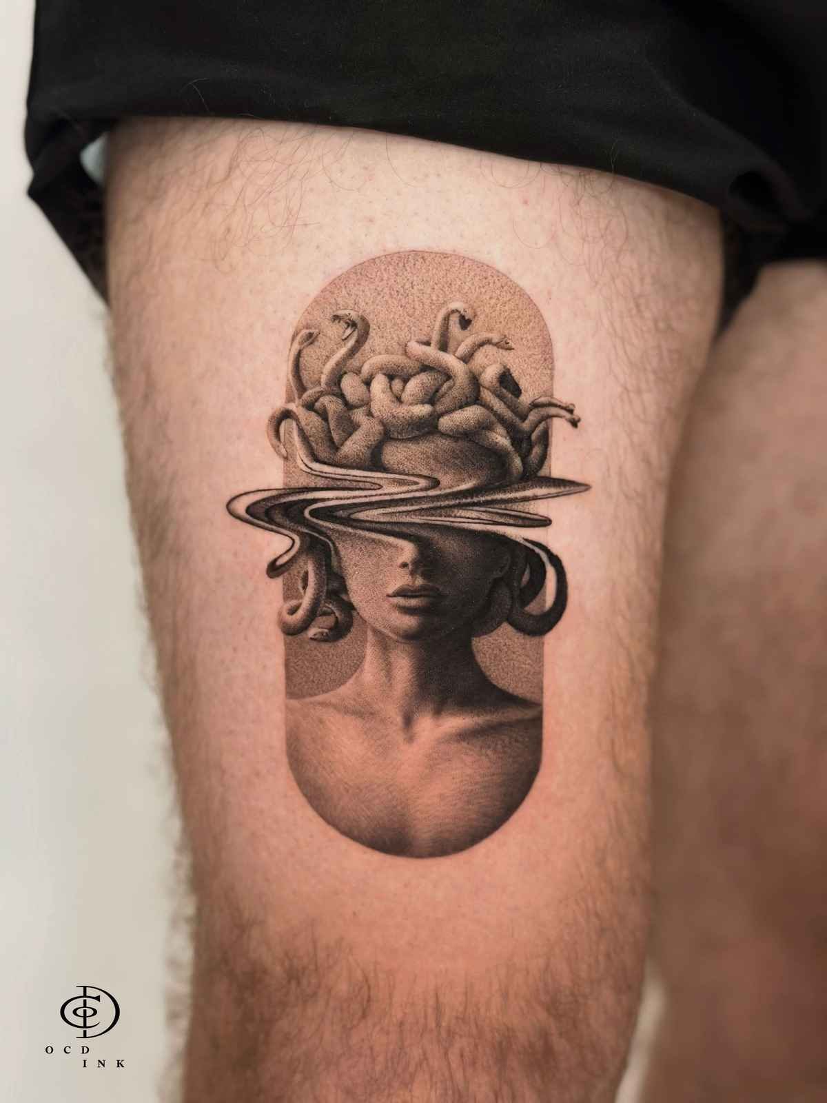 Black and grey dotwork tattoo of Medusa on the thigh, featuring intricate stipple shading, a surreal flowing band across the eyes, and detailed snake hair framed within a vertical geometric shape.