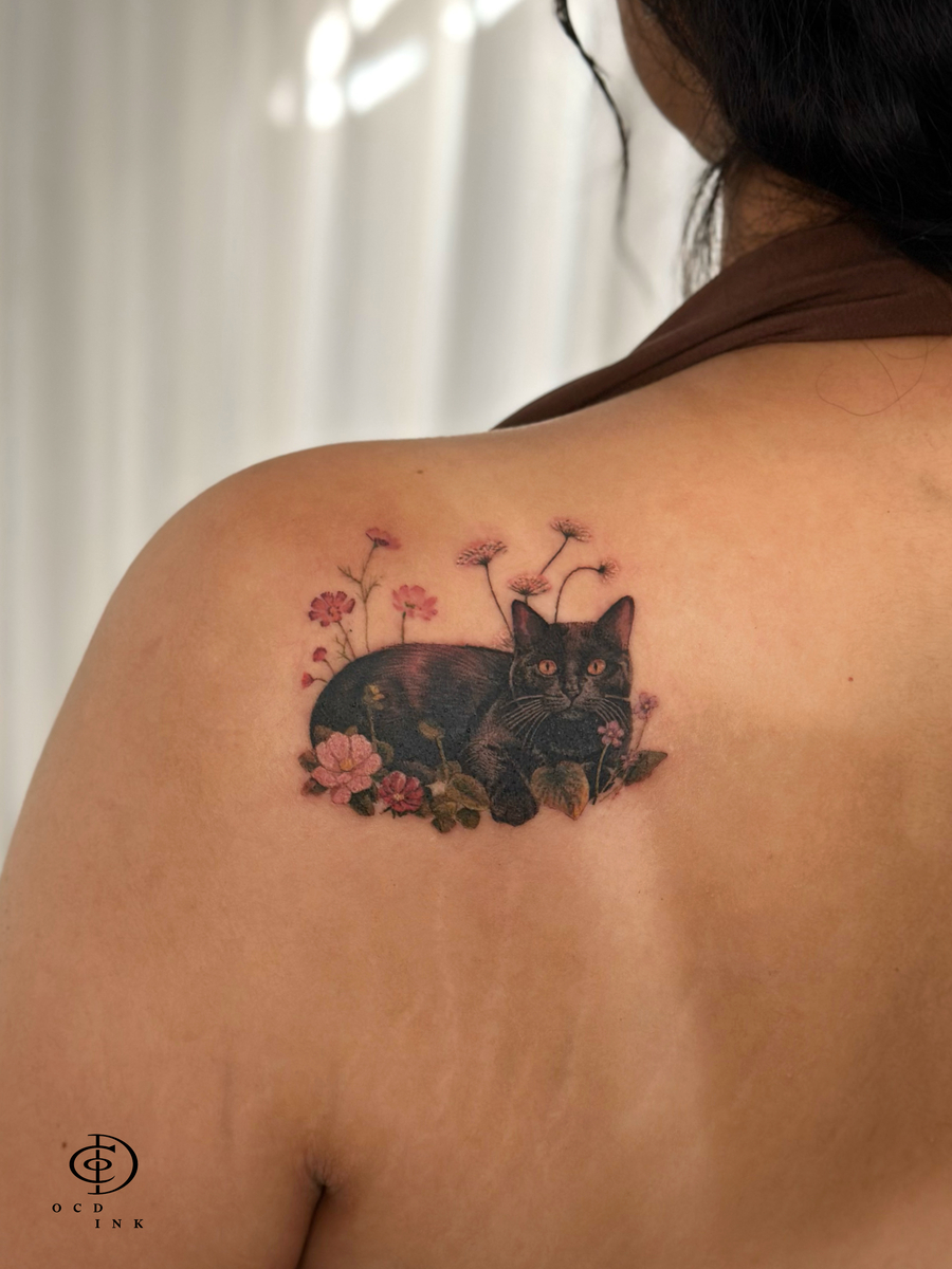 realistic black cat with colorful tattoo - OCD Ink Studio