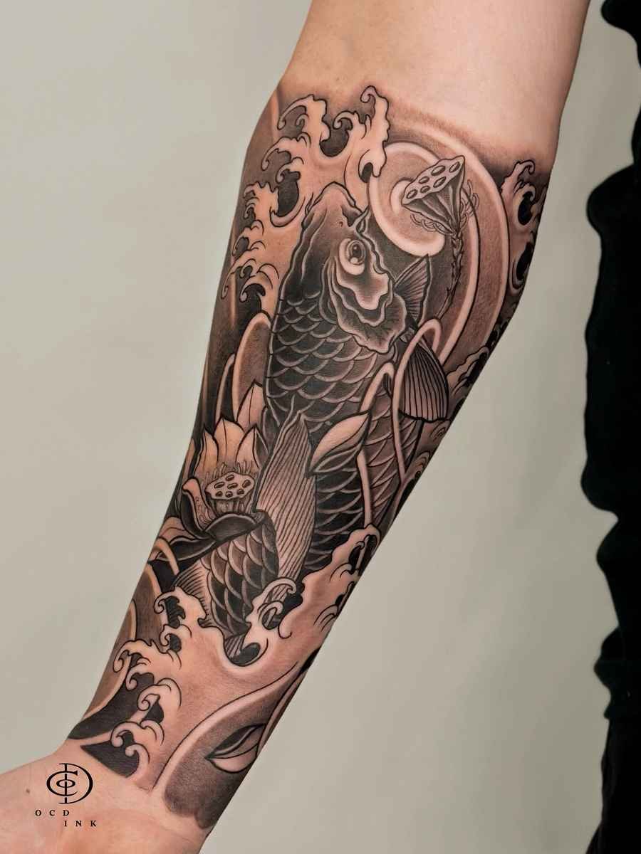 Japanese-style black-and-gray koi fish tattoo sleeve featuring a large koi swimming through stylized waves, lotus flowers, and flowing water motifs