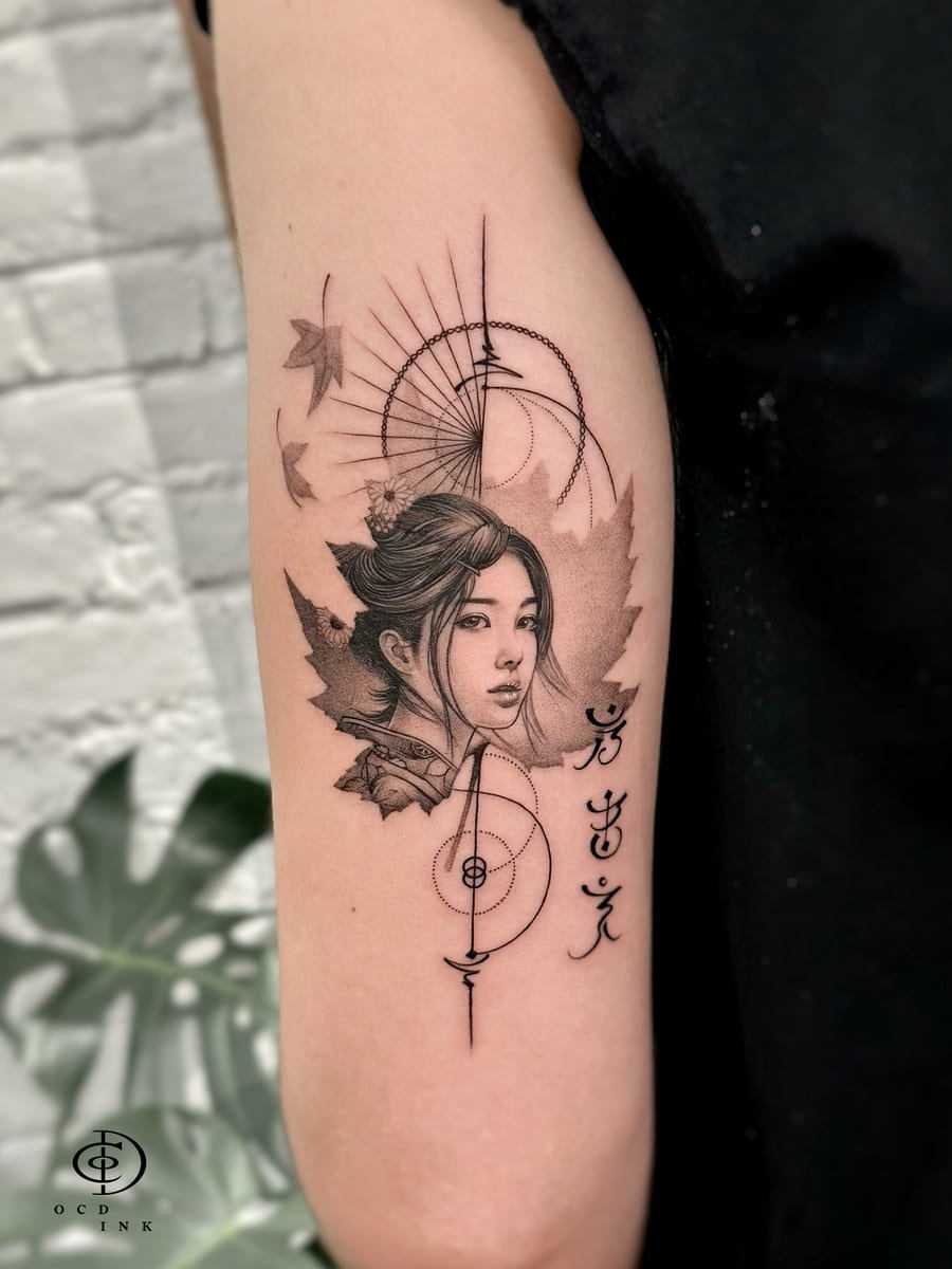 graphic tattoo featuring a woman’s portrait, maple leaves, geometric circles, fine lines, and abstract symbols
