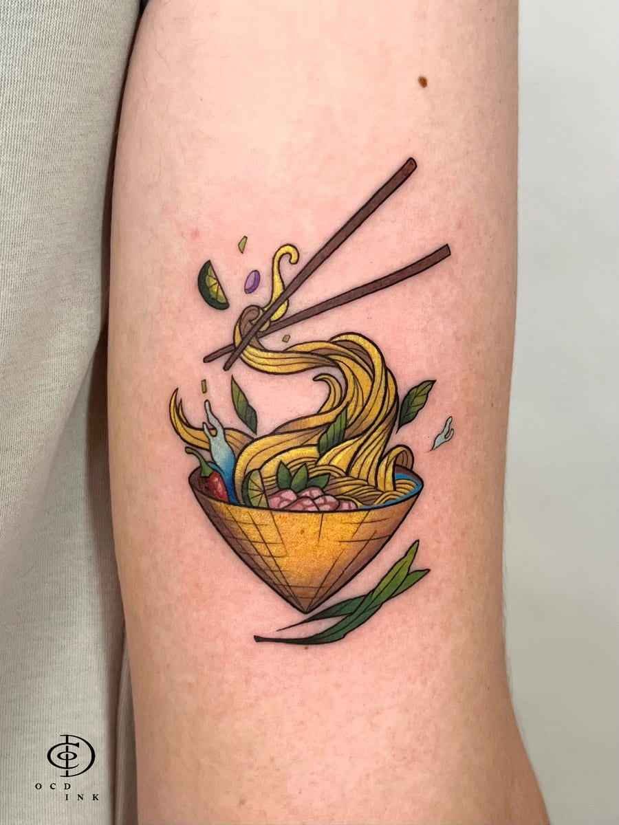 ILLUSTRATION Colorful illustration tattoo of a noodle bowl with chopsticks, flowing noodles, herbs, and lime
