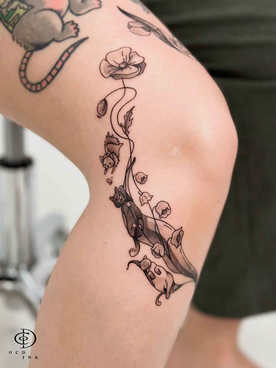 ILLUSTRATION Illustration tattoo of playful mice climbing among delicate flowers and winding stems on the upper arm