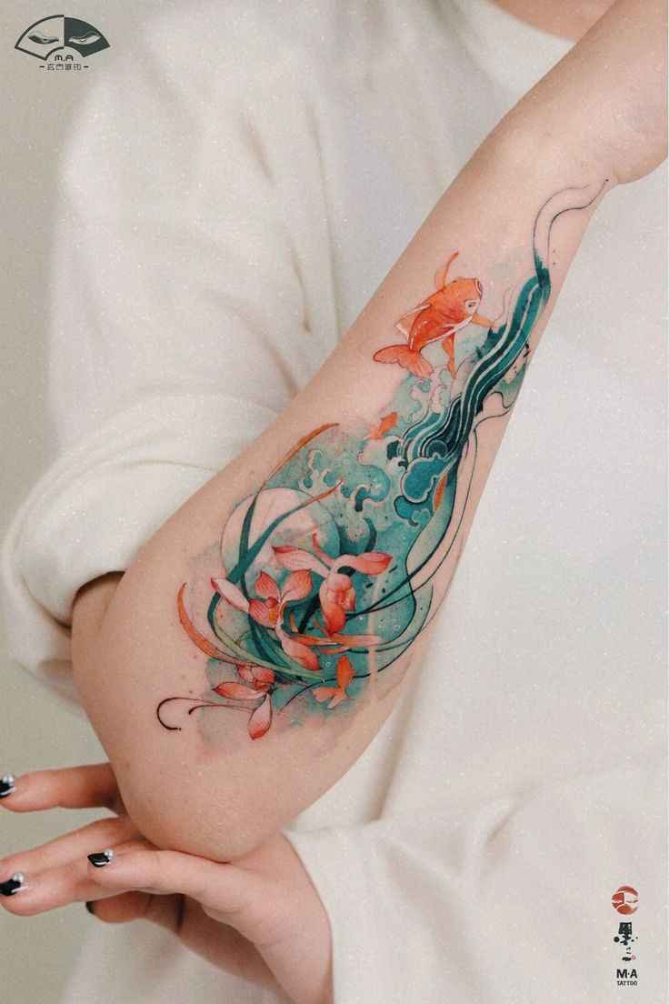 ILLUSTRATION Illustration tattoo of orange koi fish swimming through teal waves and flowers along the arm.