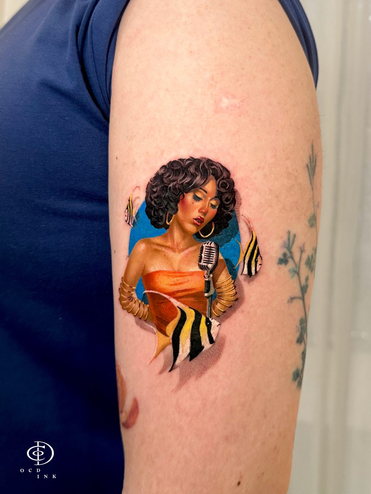 Color portrait tattoo of Kali Uchis with realistic facial details, rich tones, and smooth shading for a lifelike finish tattoo on the arm by OCD Ink Studio in Hanoi